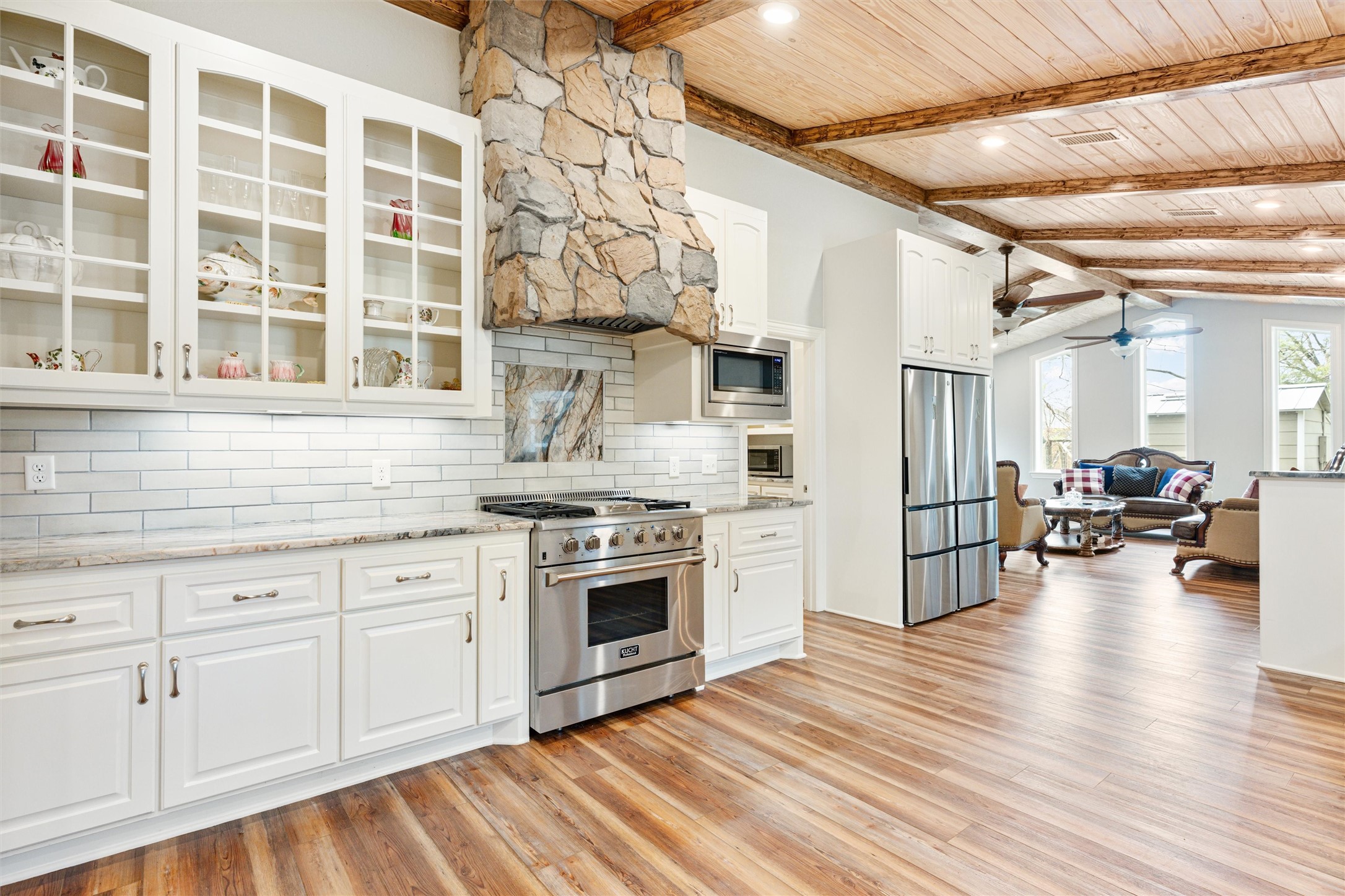 10602 Ward Road Tomball, TX 77375 - Photo 36 of 50 a kitchen with cabinets and wooden floor
