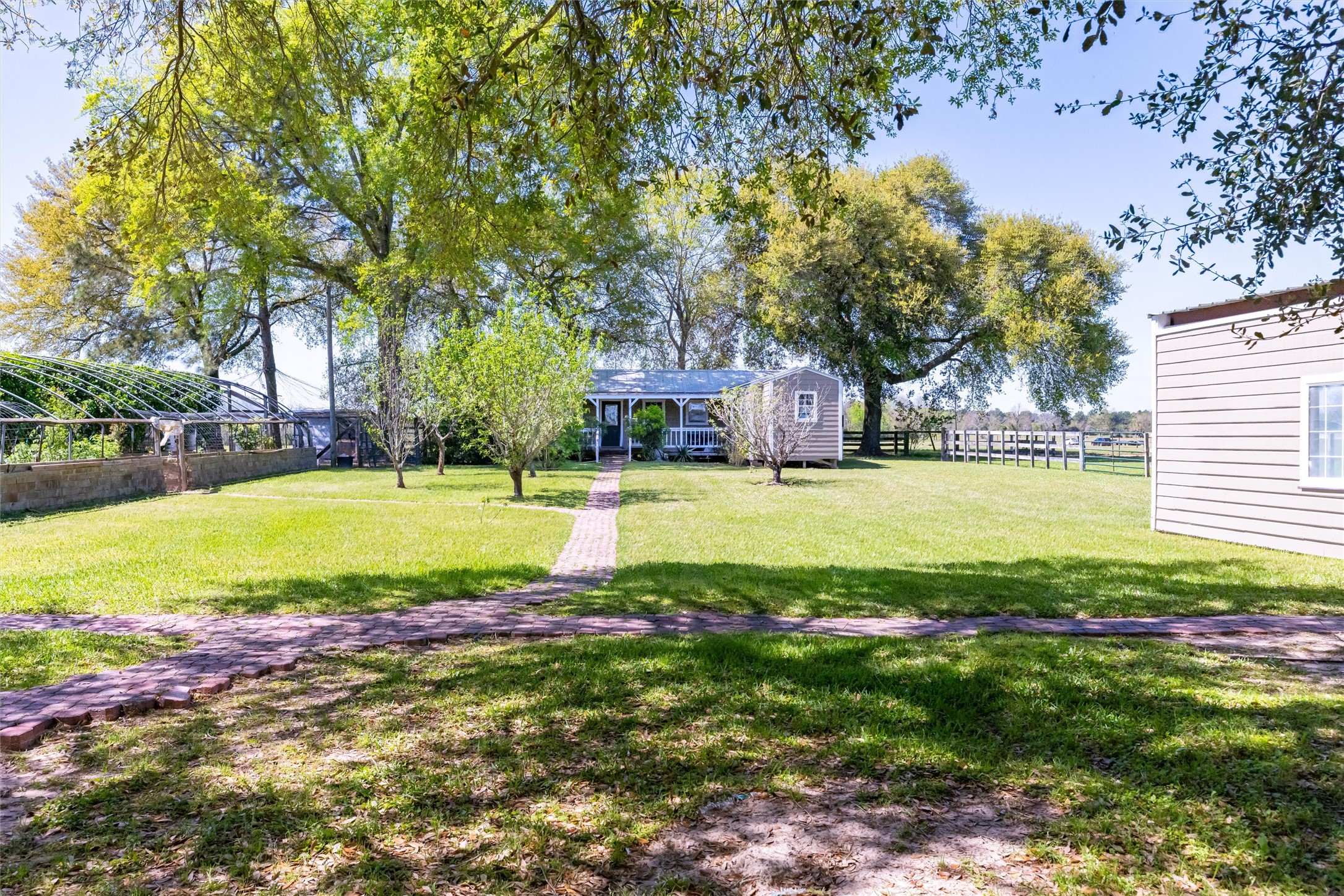 10602 Ward Road Tomball, TX 77375 - Photo 47 of 50 a view of a swimming pool with lawn chairs and large trees