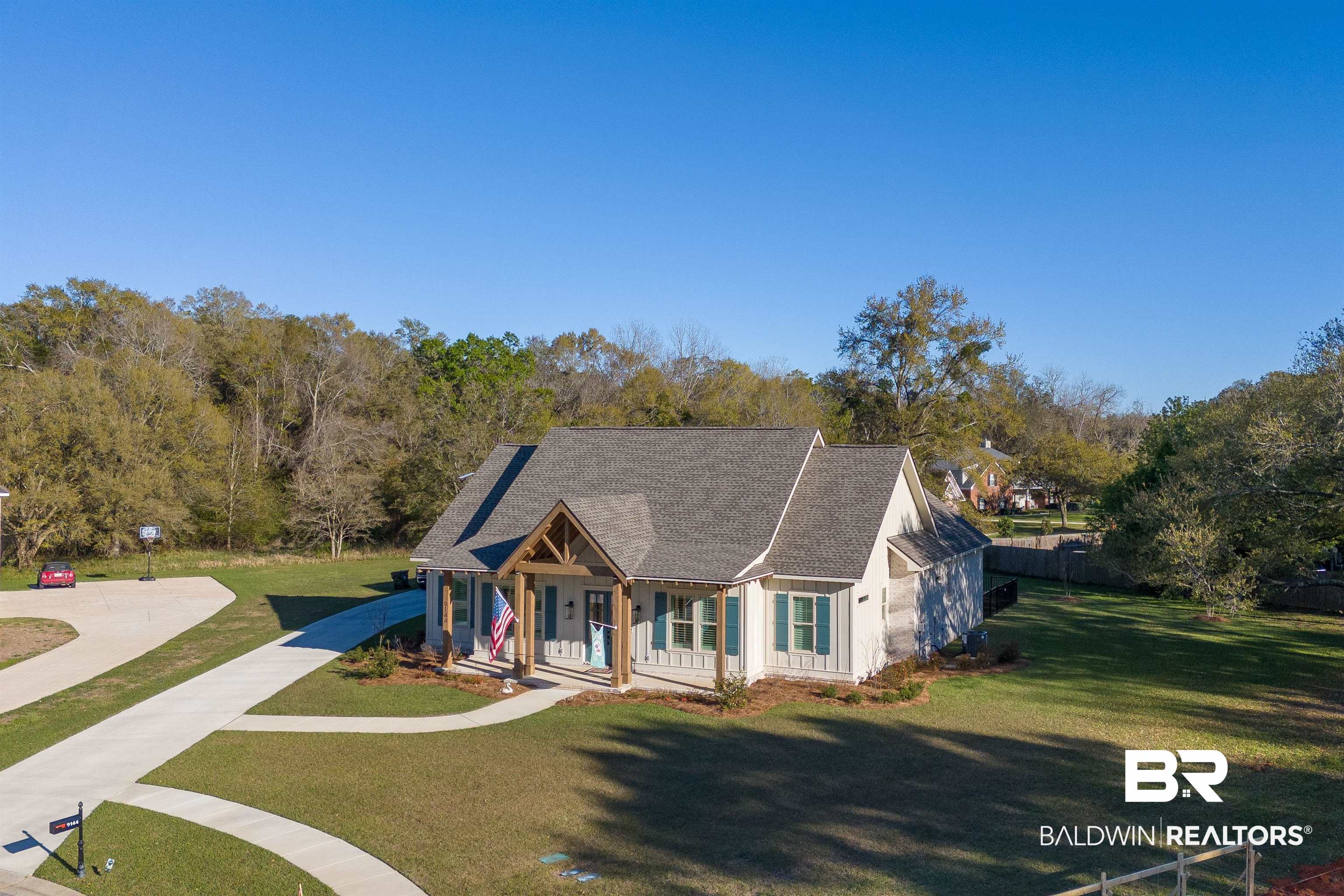 9144 Harvest Ridge Fairhope, AL 36532 - Photo 9 of 58 View of front of property with a shingled roof, fence, a porch, and a front yard