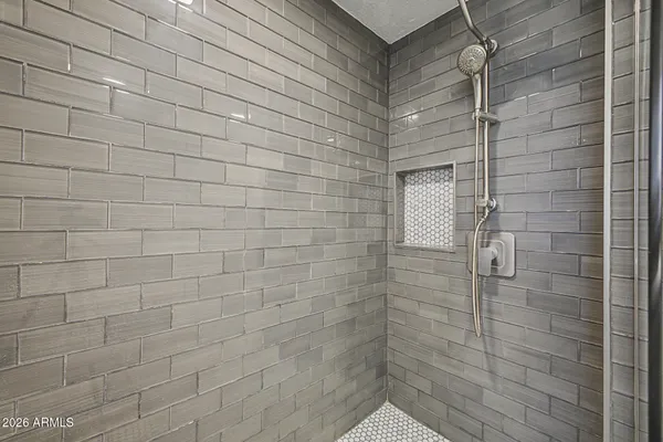 a bathroom with a shower and a glass door
