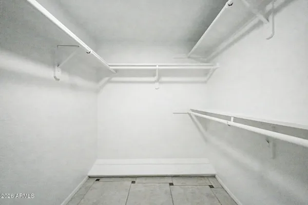 an empty room with a ceiling fan and carpet