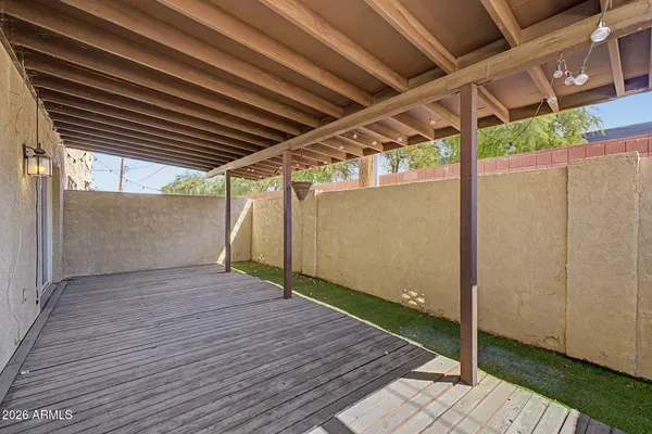a view of a porch with wooden floor