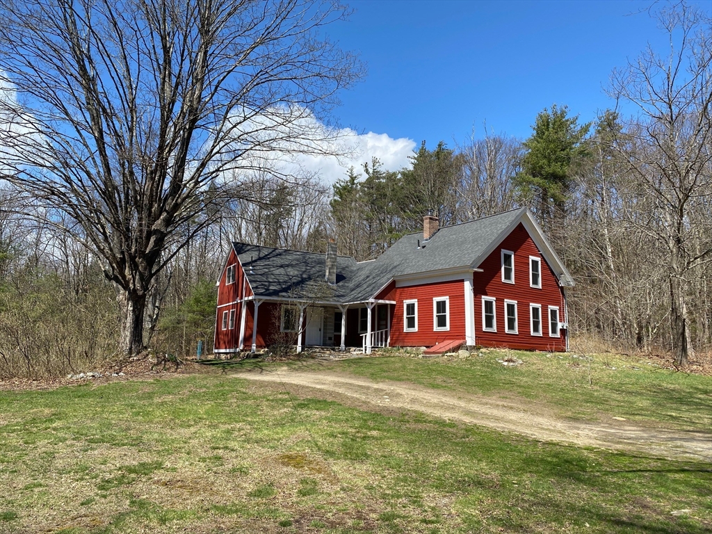 142 Flower Hill Road Warwick, MA 01378 - Photo 1 of 35 a front view of a house with a yard