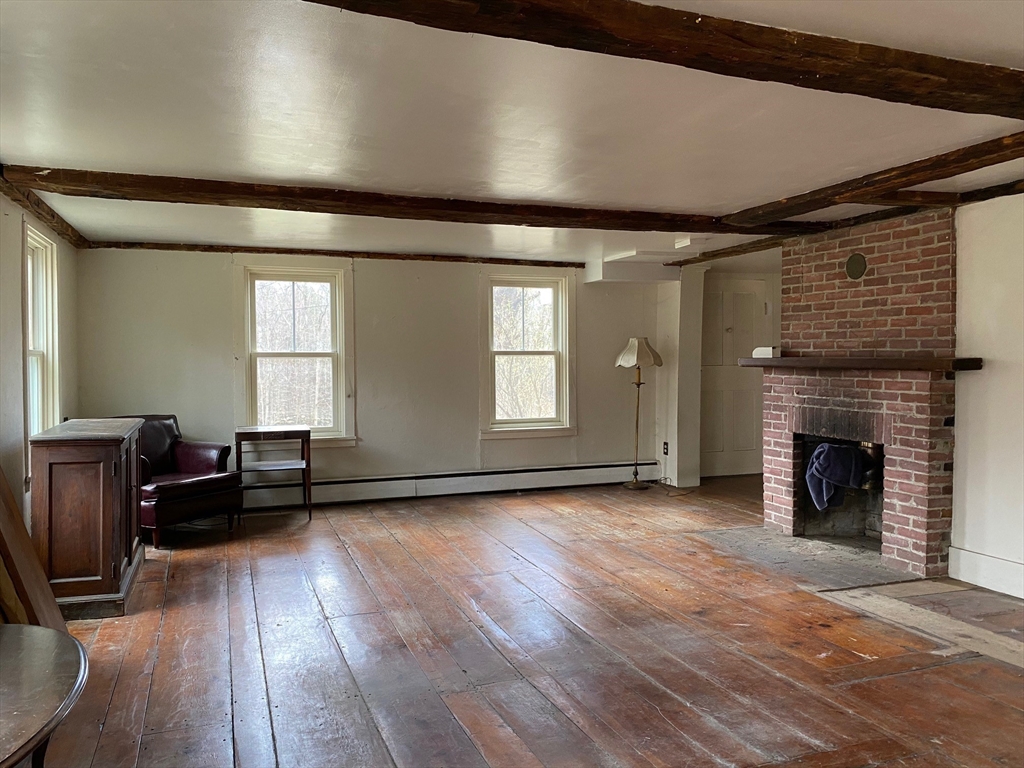 142 Flower Hill Road Warwick, MA 01378 - Photo 13 of 35 a view of empty room with wooden floor and fireplace