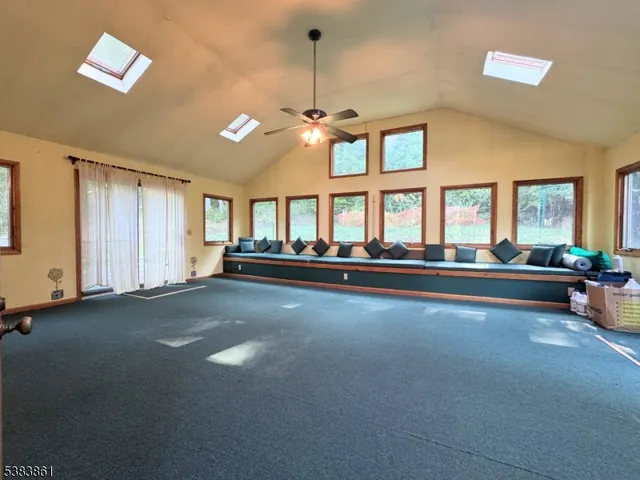 a living room with furniture and large windows