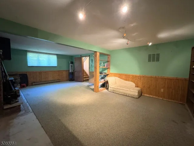 a view of a house with wooden deck and furniture
