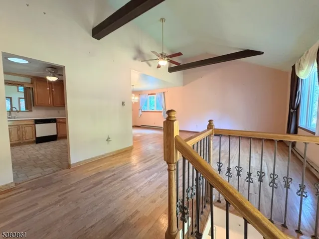 a view of staircase with railing and white walls