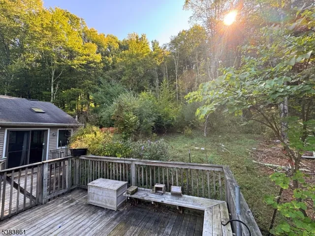 a view of a house with a yard and tree s