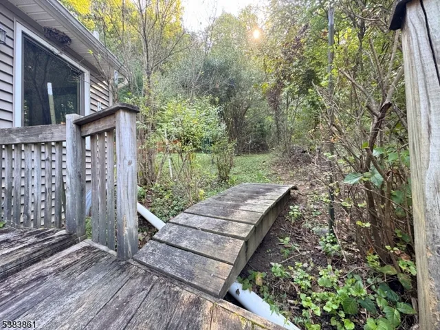 a backyard of a house with lots of green space and trees all around