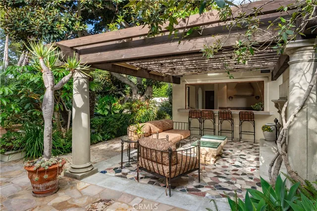 a view of patio with a table and chairs and potted plants