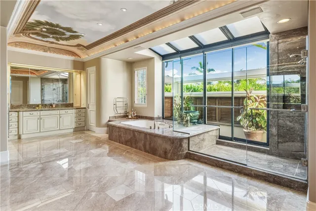 a large spacious bathroom with a large tub and shower