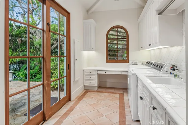 a spacious bathroom with a granite countertop sink and a large mirror