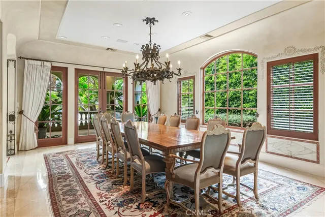 a view of a dining room with furniture wooden floor and chandelier