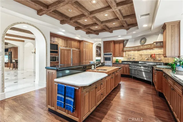 a kitchen with stainless steel appliances a sink stove and cabinets