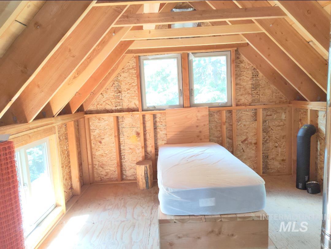 524 Rhett Creek Road Elk City, ID 83525 - Photo 12 of 23 Wood-paneled walls and ceiling framing with exposed beams
