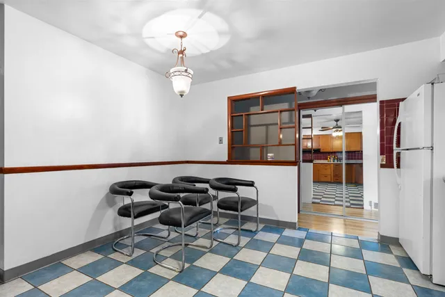 a room with gym equipment and glass doors