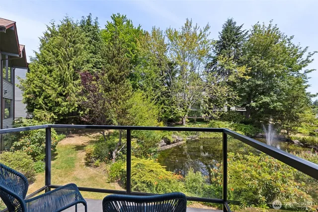 a view of city from a balcony with outdoor seating
