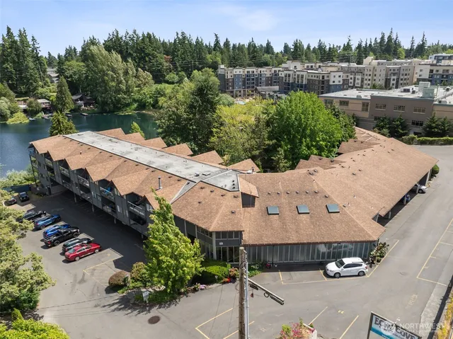 an aerial view of a house with a yard and lake view