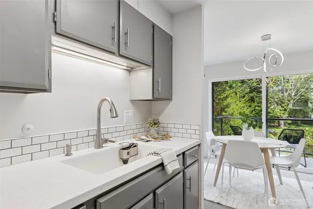 a kitchen with a table and chairs