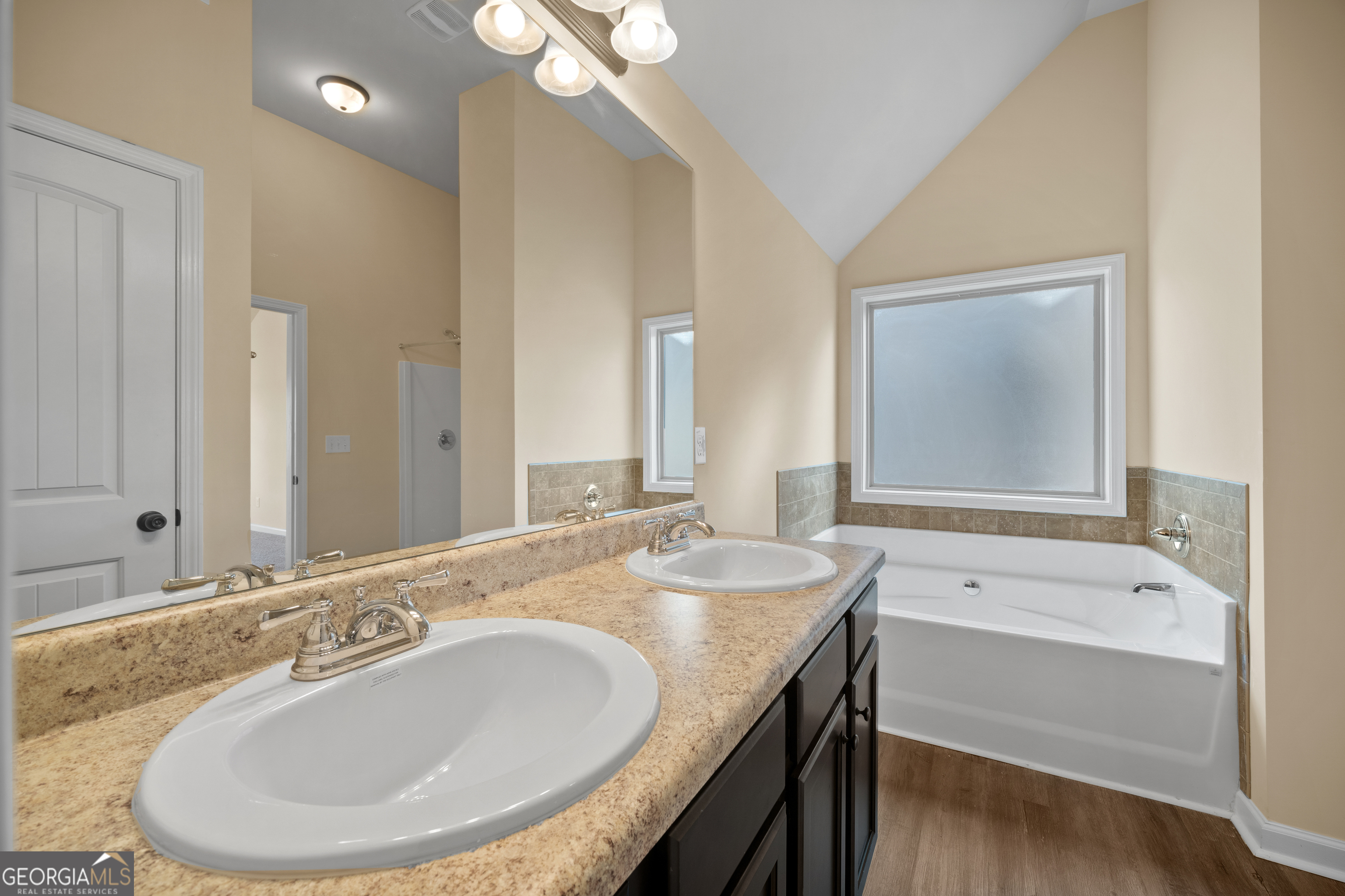 2381 Aukerman Trace, Unit 81 Hampton, GA 30228 - Photo 16 of 17 a bathroom with a granite countertop sink and a mirror