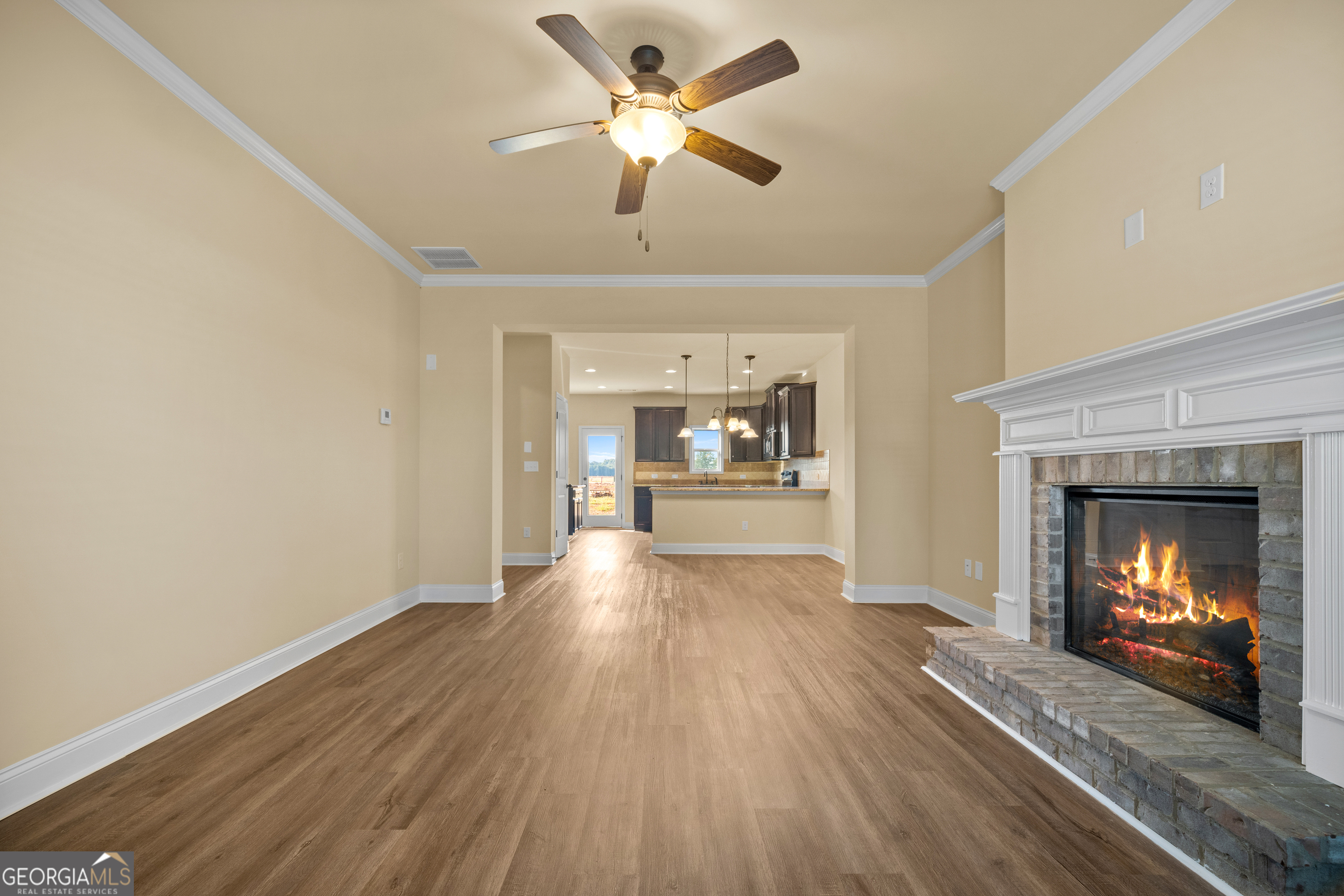 2381 Aukerman Trace, Unit 81 Hampton, GA 30228 - Photo 3 of 17 a view of an empty room with a fireplace and a ceiling fan