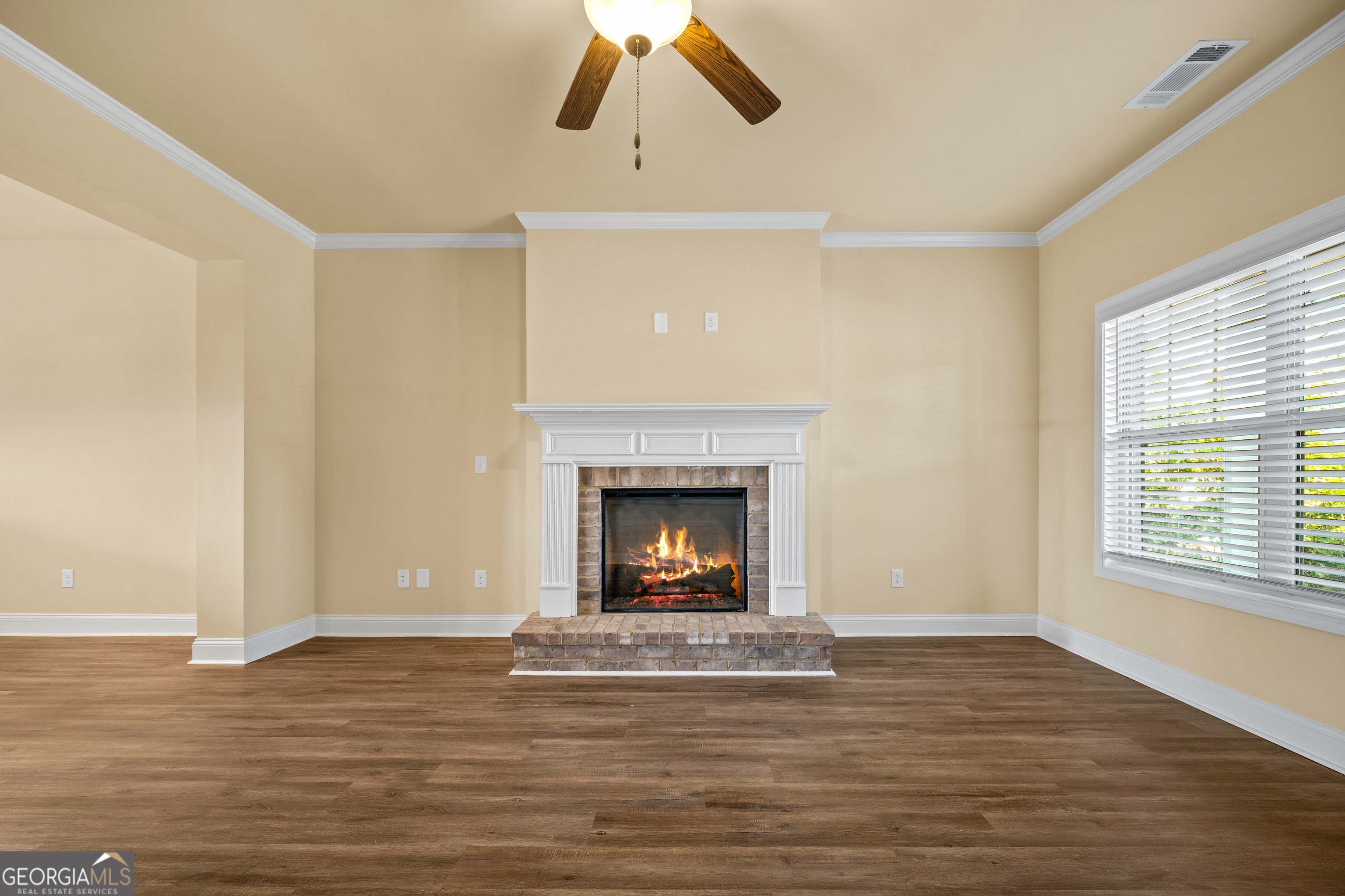 2381 Aukerman Trace, Unit 81 Hampton, GA 30228 - Photo 4 of 17 a view of an empty room with wooden floor fireplace and a window