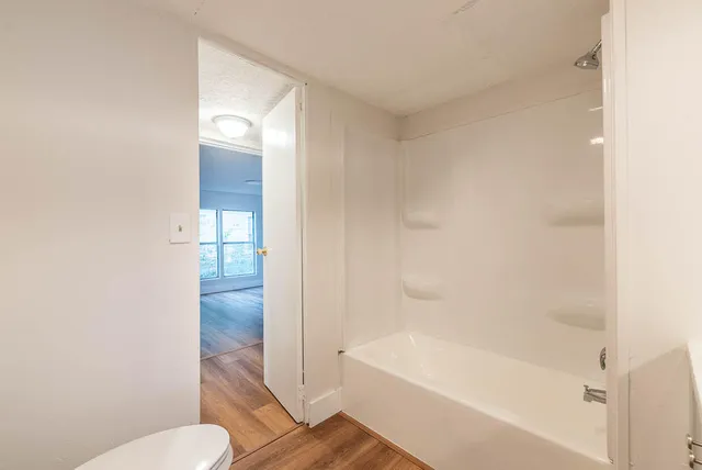 a bathroom with a bathtub and toilet