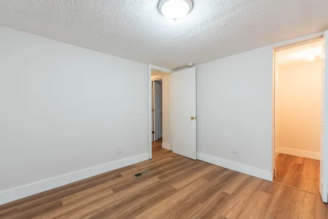 a view of room with wooden floor