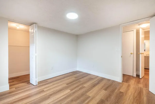 a view of a room with wooden floor