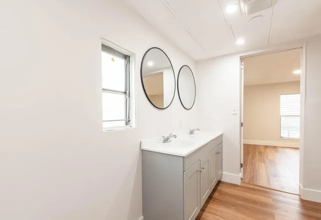 a bathroom with a double vanity sink a and a mirror