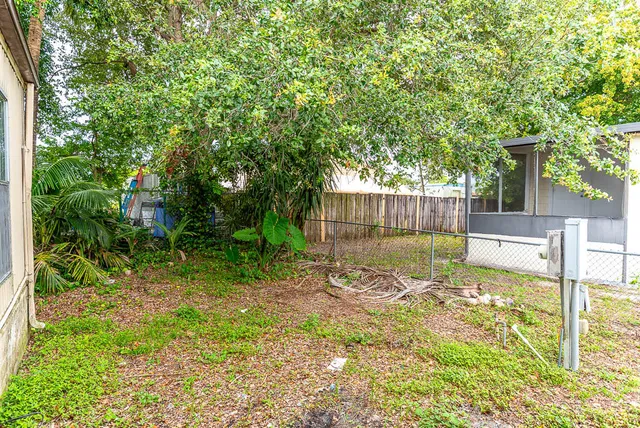 a backyard of a house with table and chairs