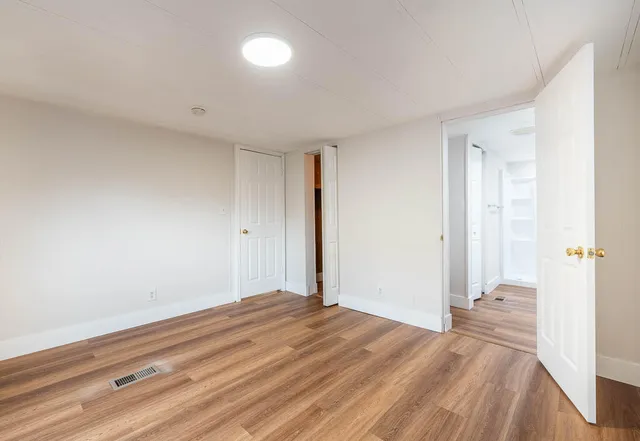 a view of a room with wooden floor