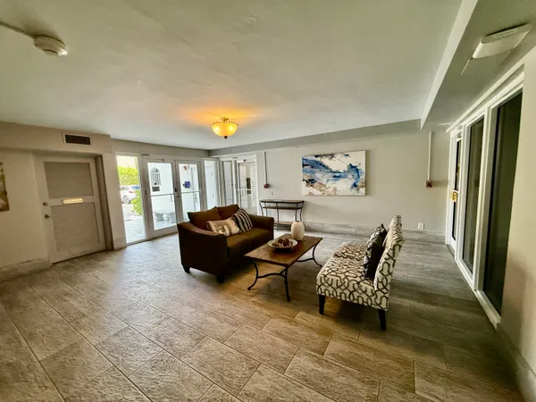 a front view of a house with a garden and trees