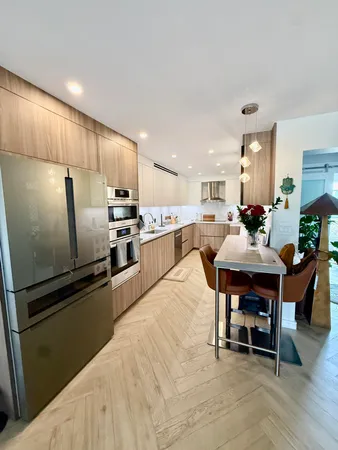 a kitchen with stainless steel appliances granite countertop a sink and a cabinets