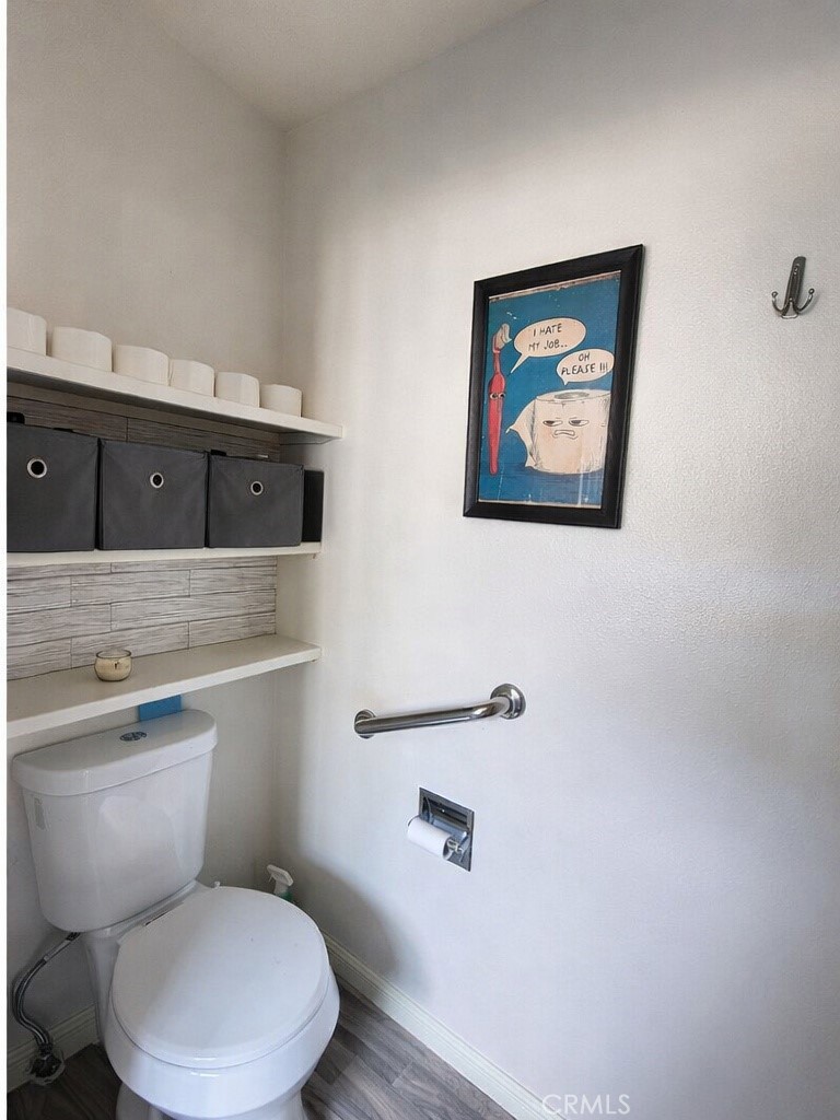 633 East Walnut Street Willows, CA 95988 - Photo 16 of 21 a white toilet sitting next to a bathroom sink