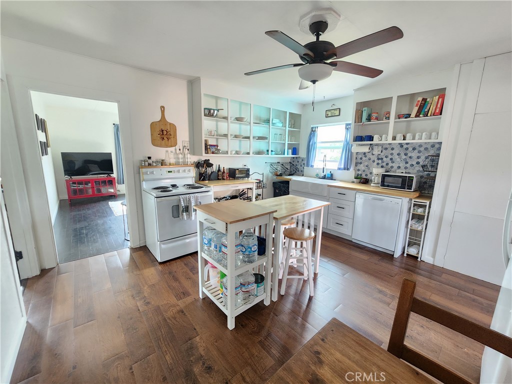 633 East Walnut Street Willows, CA 95988 - Photo 5 of 21 a living room with granite countertop furniture a fireplace and a dining table with wooden floor