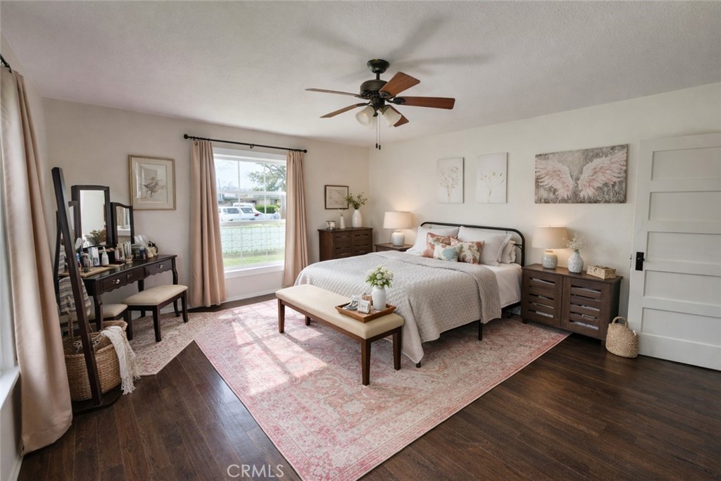 633 East Walnut Street Willows, CA 95988 - Photo 6 of 21 a bedroom with a bed and wooden floor