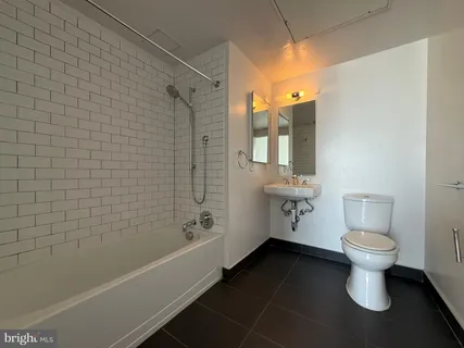 a bathroom with a toilet a sink and bathtub