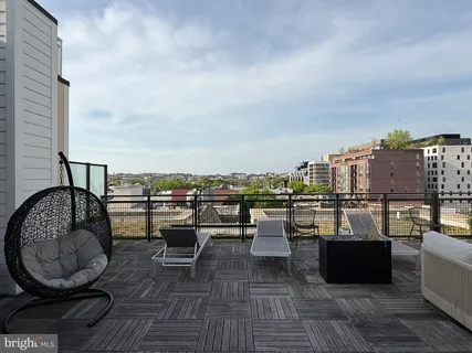 a view of roof deck with seating space and barbeque oven