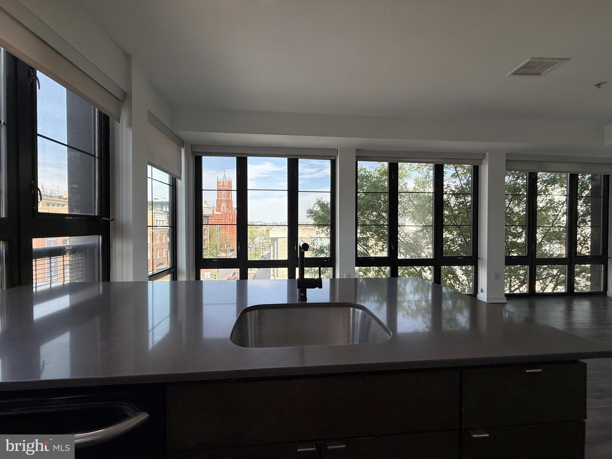 1250 9th Street Northwest, Unit 411 Washington, DC 20001 - Photo 4 of 22 a view of a dining room with furniture large windows and wooden floor
