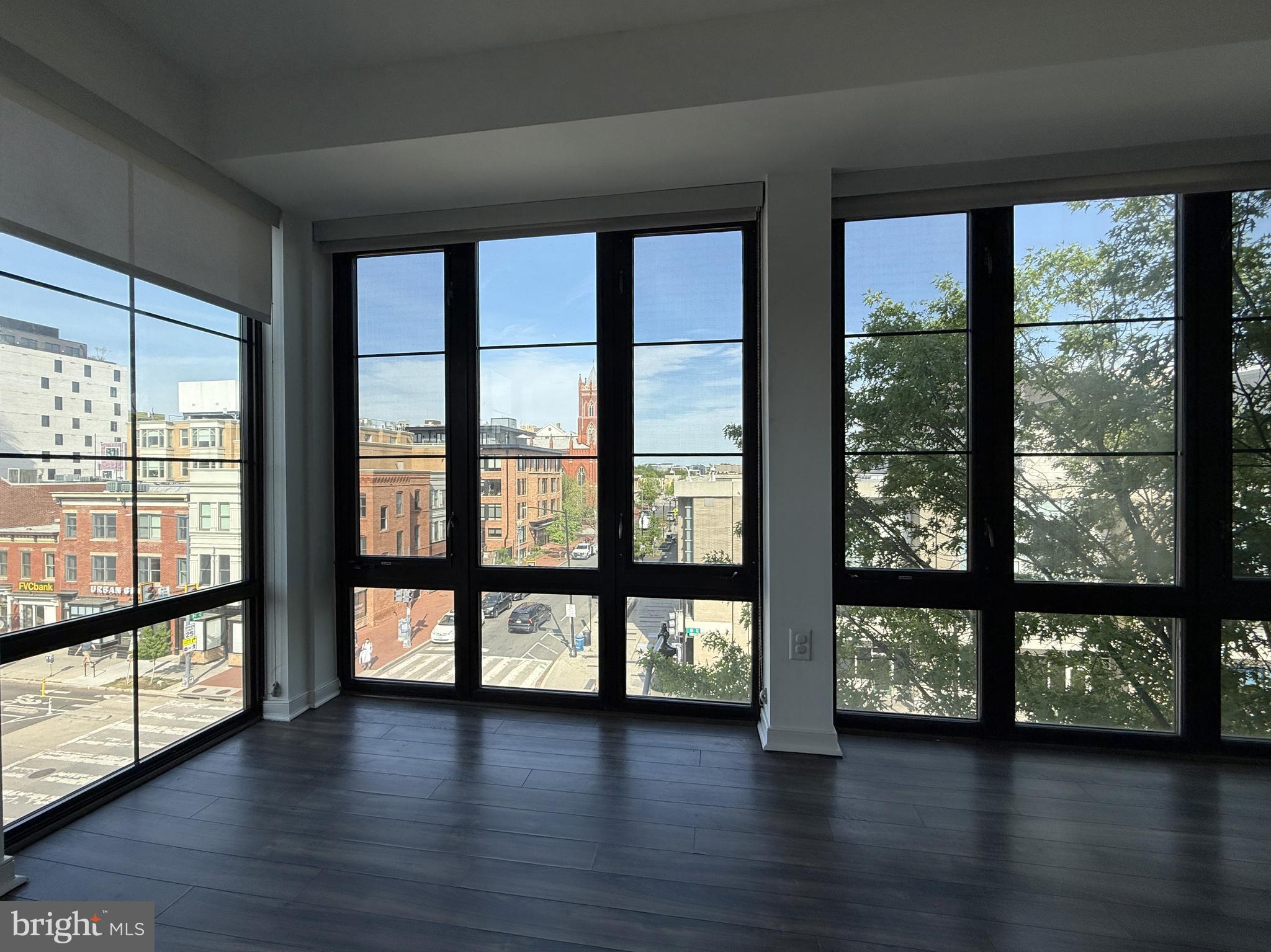 1250 9th Street Northwest, Unit 411 Washington, DC 20001 - Photo 6 of 22 a view of a large window with wooden floor and outside view