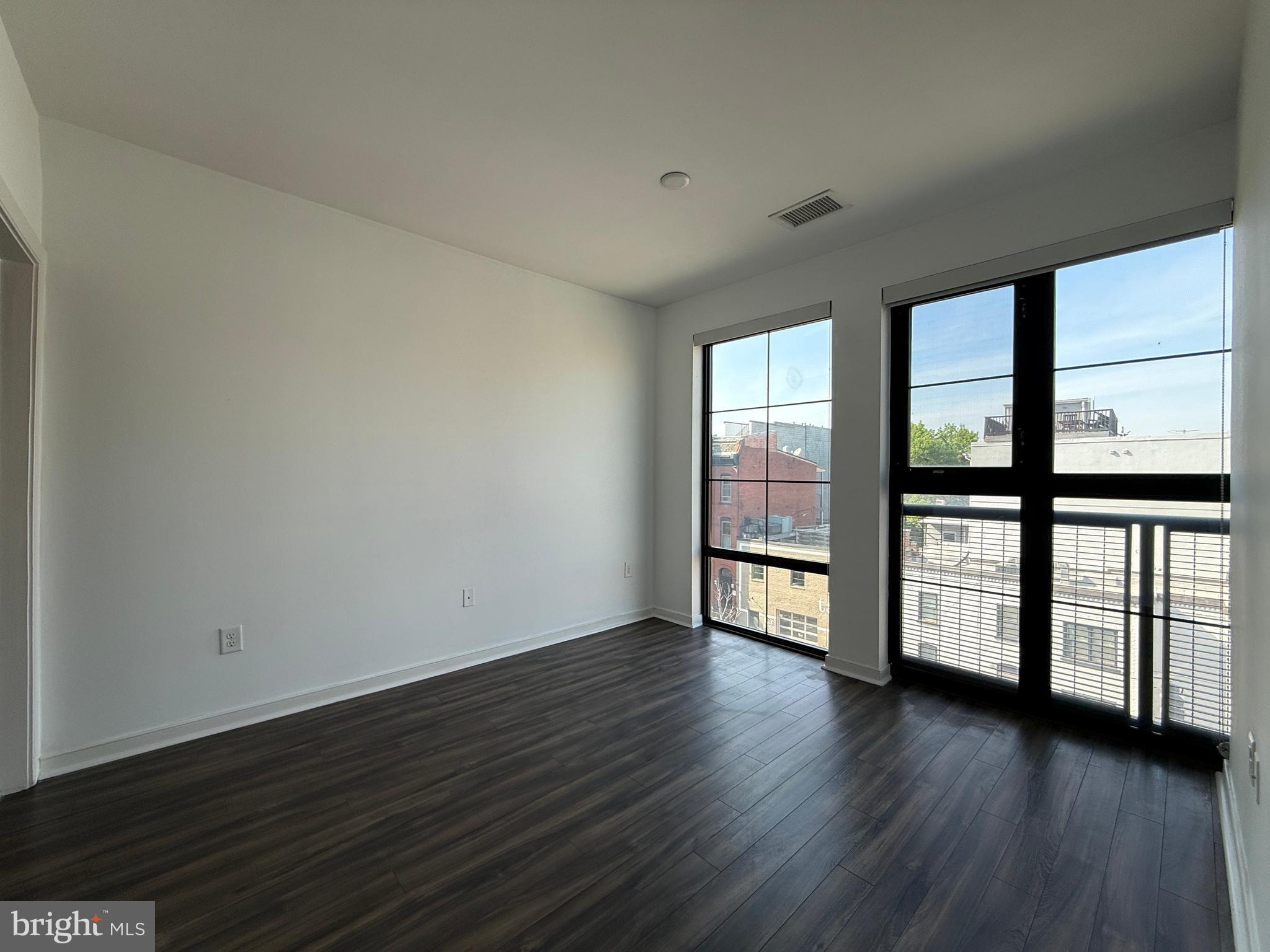 1250 9th Street Northwest, Unit 411 Washington, DC 20001 - Photo 9 of 22 wooden floor in an empty room with a window