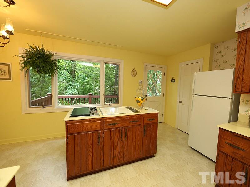 8600 Valley Brook Drive Raleigh, NC 27613 - Photo 8 of 25 a room with a sink a bed and a refrigerator