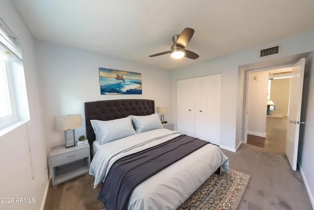 a bedroom with bed and window