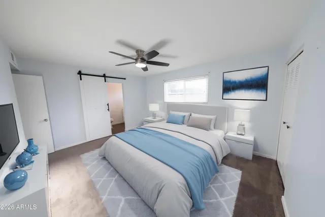 a bedroom with a large bed and a flat screen tv