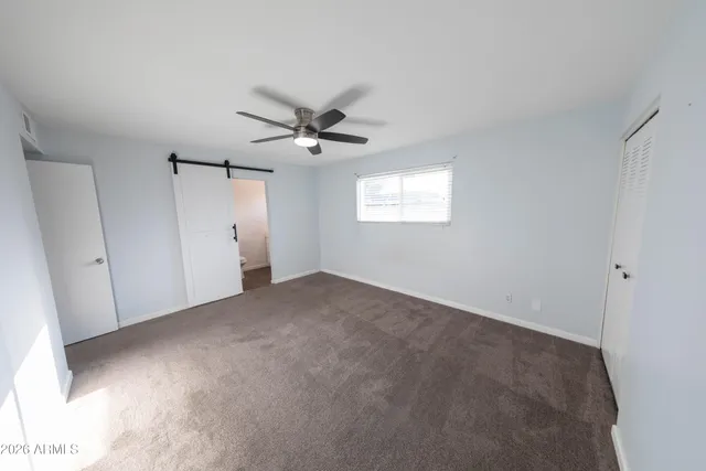 a view of a livingroom with a ceiling fan and window