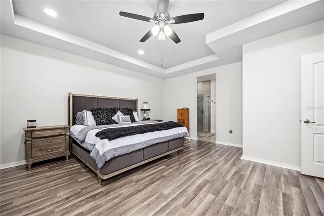 a bedroom with a bed and a ceiling fan
