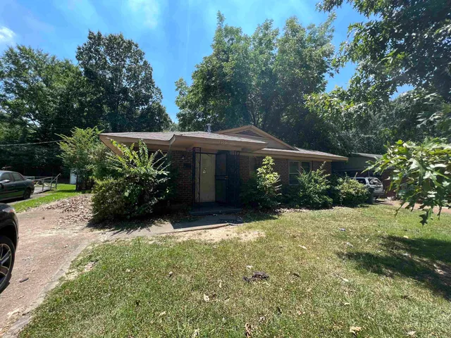 a view of a house with yard and a garden