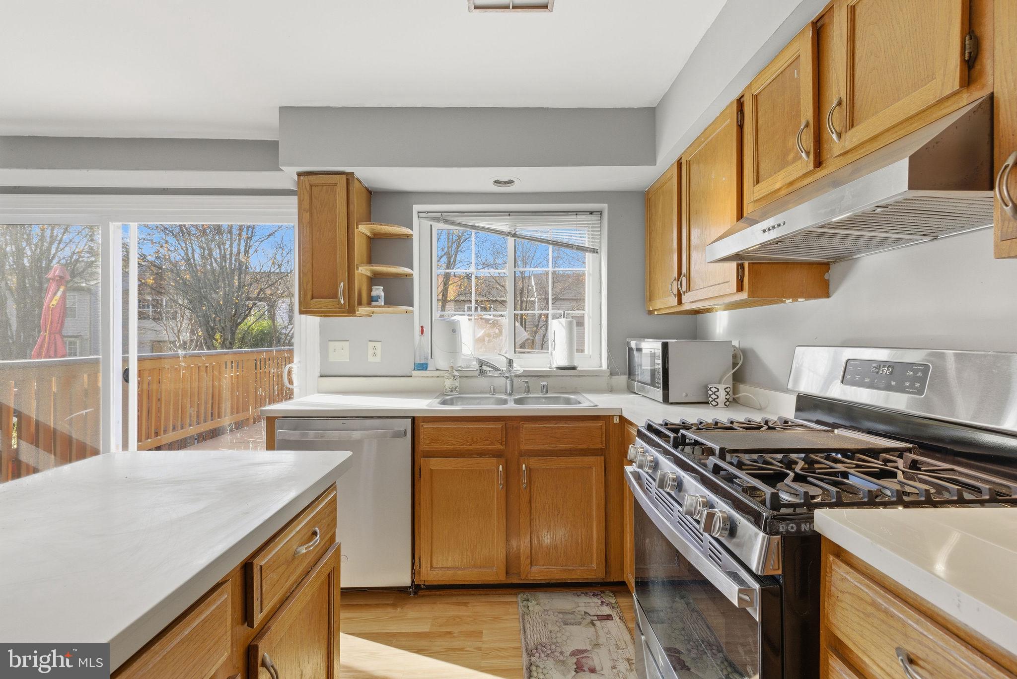 14688 Basingstoke Loop Centreville, VA 20120 - Photo 12 of 34 a kitchen with a stove a sink and a granite counter tops