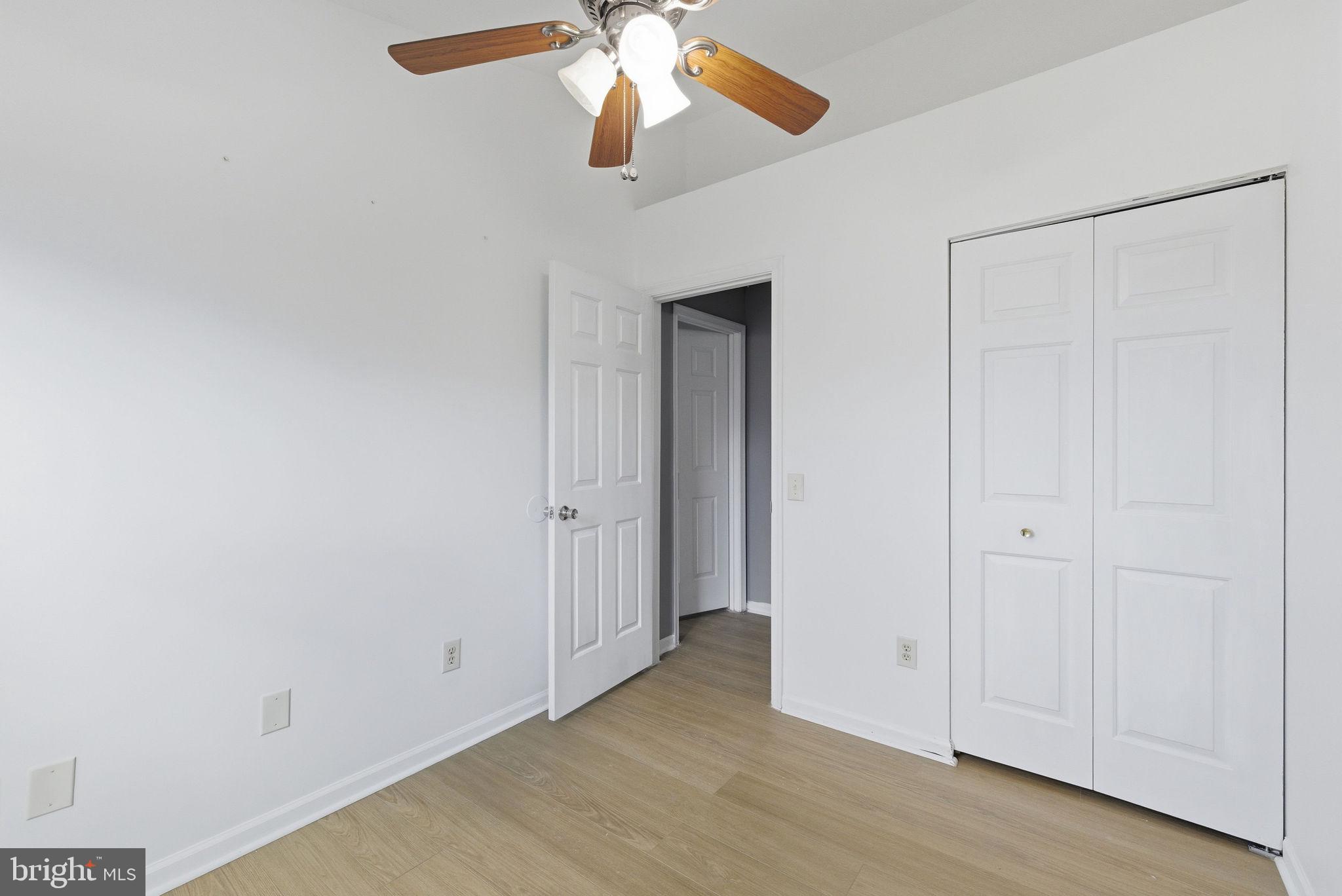 14688 Basingstoke Loop Centreville, VA 20120 - Photo 18 of 34 an empty room with closet and a chandelier fan